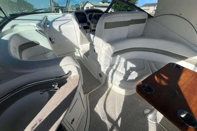 Slide: The Image of 2007 Sea Ray Sundancer 320 interior with white seating and wooden table. - 20
