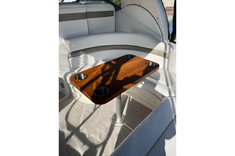 Slide: The Image of Luxurious interior of 2007 Sea Ray Sundancer 320 with wooden table and cup holders. - 25