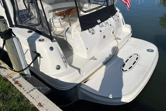 Slide: The Image of 2007 Sea Ray Sundancer 320 docked, featuring spacious deck and seating area. - 6