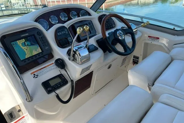 Slide: The Image of 2007 Sea Ray Sundancer 320 helm with navigation equipment and luxurious seating. - 9
