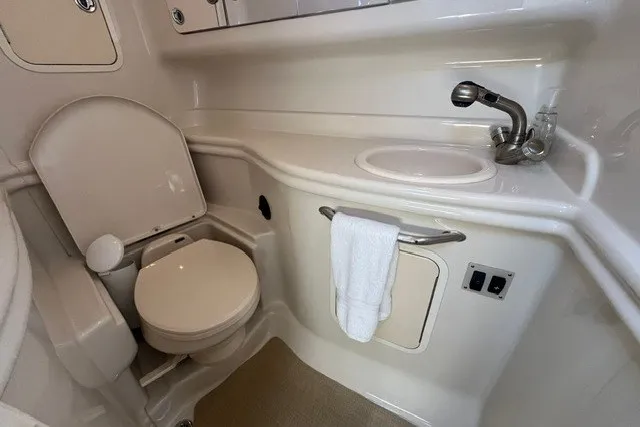 Slide: The Image of 2007 Sea Ray Sundancer 320 bathroom with toilet, sink, and towel rack. - 42