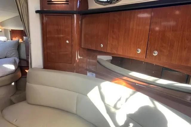 Slide: The Image of Luxurious interior of 2007 Sea Ray Sundancer 320 with wood cabinetry and plush seating. - 32