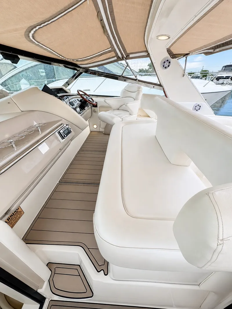 Slide: The Image of The image shows the cockpit of a 1999 Sea Ray 500 Sundancer with elegant white seating. - 17