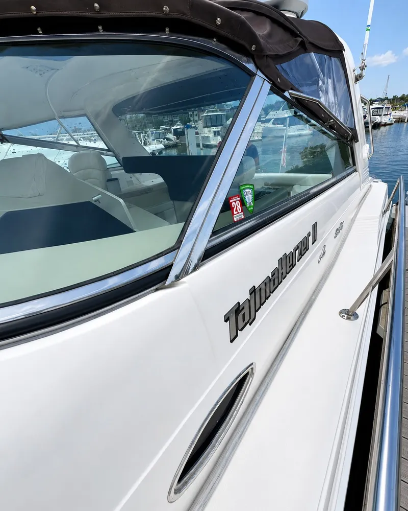 Slide: The Image of A 1999 Sea Ray 500 Sundancer docked. The name "Tajmahalerer II" is visible. - 8