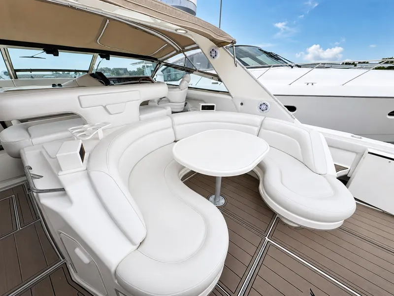 Slide: The Image of The image shows the cockpit of a 1999 Sea Ray 500 Sundancer with elegant white seating. - 13
