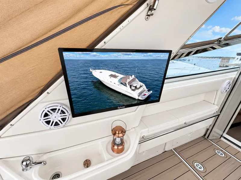 Slide: The Image of Interior of a 1999 Sea Ray 500 Sundancer with a screen displaying a boat. - 10