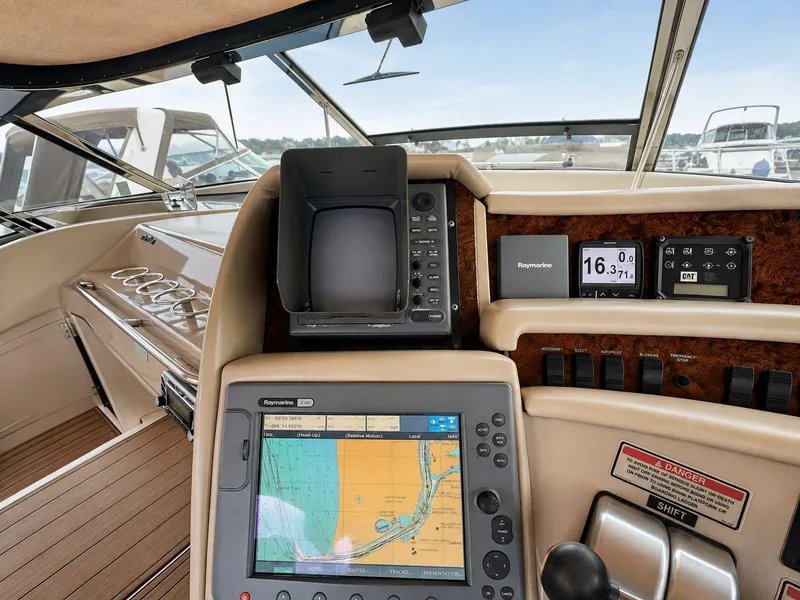 Slide: The Image of The cockpit of the 1999 Sea Ray 500 Sundancer features modern navigation equipment and sleek design. - 21