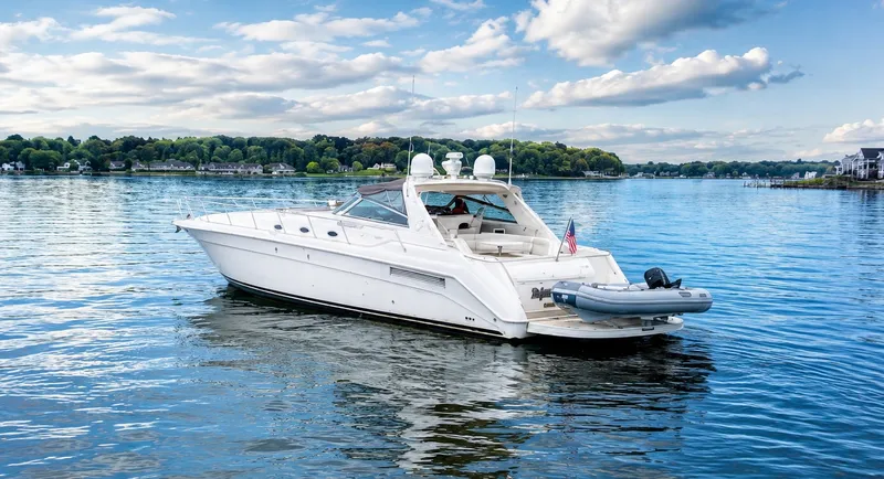 Slide: The Image of A 1999 Sea Ray 500 Sundancer on a calm lake with a cloudy sky. - 1