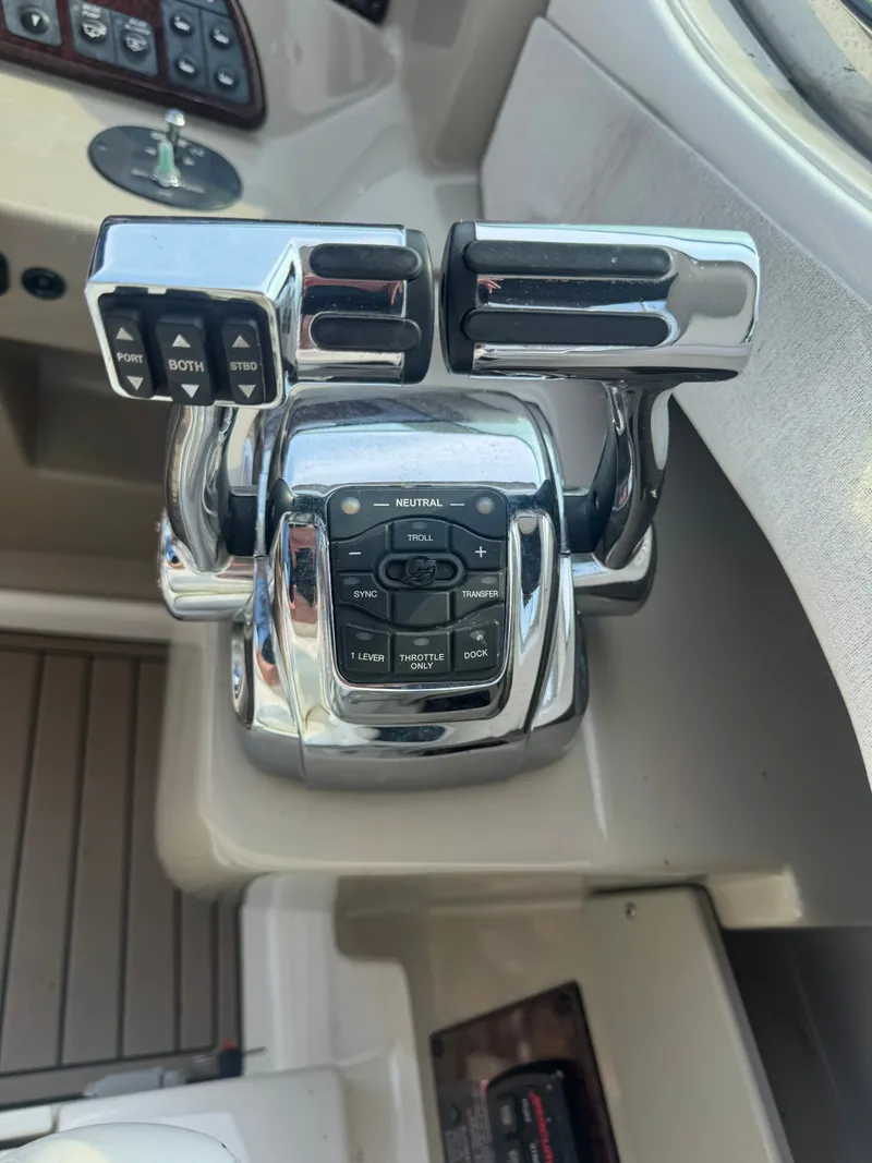 Slide: The Image of Close-up of the control console on a 2008 Sea Ray 290 Sundancer with shiny levers. - 13