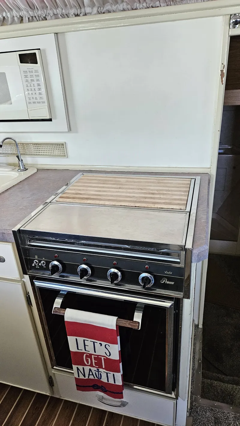Slide: The Image of A kitchen with a stove and a towel reading "LET'S GET NAUTI." - 31