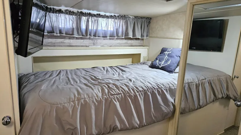 Slide: The Image of The image shows a cozy cabin with a bed, a pillow, and a wall-mounted TV. - 41