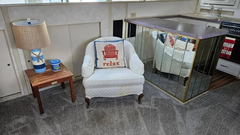 Slide: The Image of A cozy seating area with an armchair, a 'relax' pillow, and a side table. - 22