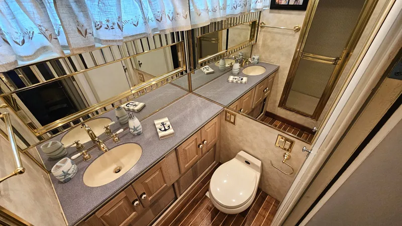Slide: The Image of The image shows an elegant bathroom with wood flooring, double sinks, and gold fixtures. - 42