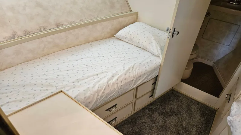 Slide: The Image of The 1971 Chris-Craft 47 Commander cabin features a single bed with drawers underneath. - 49