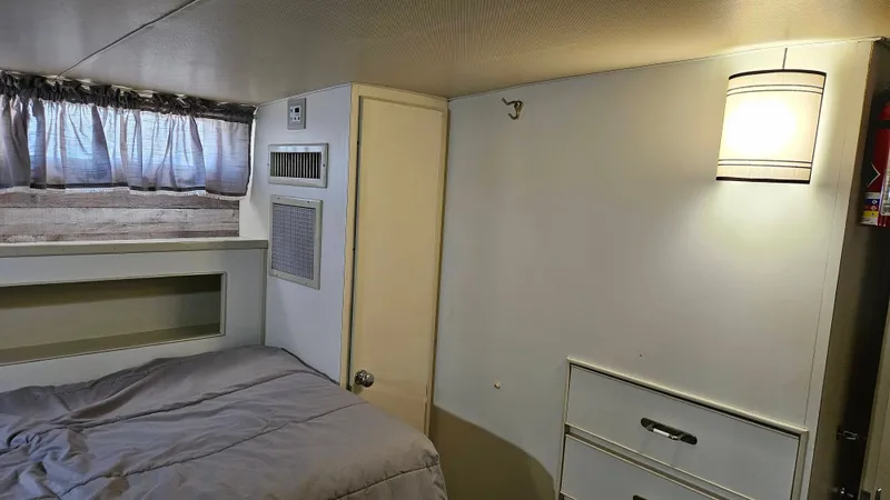 Slide: The Image of Interior of a 1971 Chris-Craft 47 Commander with bed, cabinet, and curtains. - 39