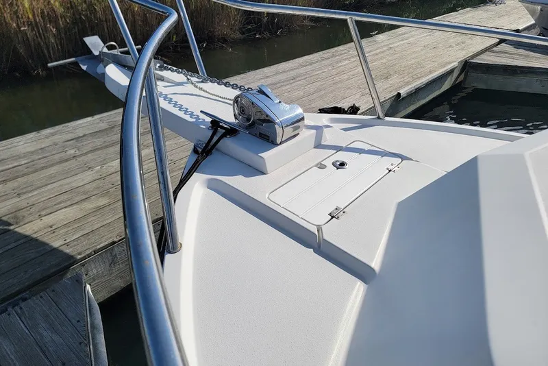 Slide: The Image of 2017 Parker 2120 Sport Cabin boat bow with anchor and railing at dock. - 16