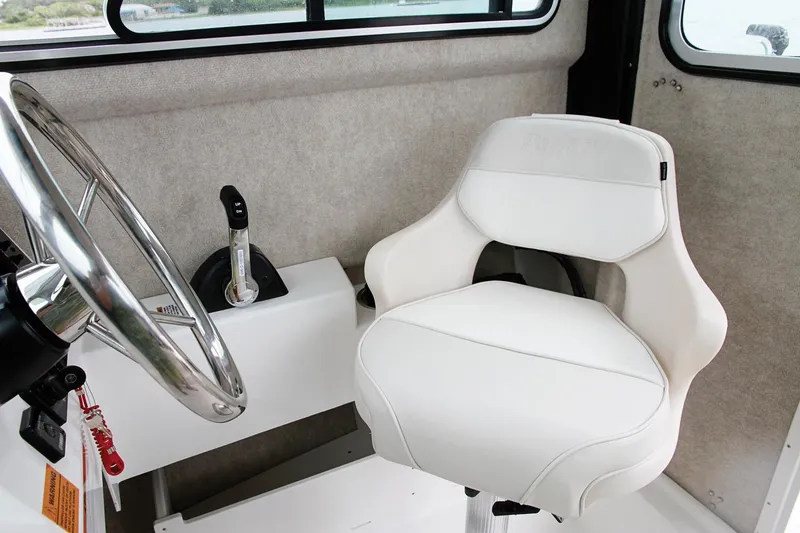 Slide: The Image of Manufacturer Provided Image: Captain's chair and steering wheel of a 2017 Parker 2120 Sport Cabin boat. - 2