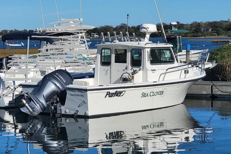 The Image of 2017 Parker 2120 Sport Cabin boat named "Sea Clover" docked with Yamaha outboard motor. - 0