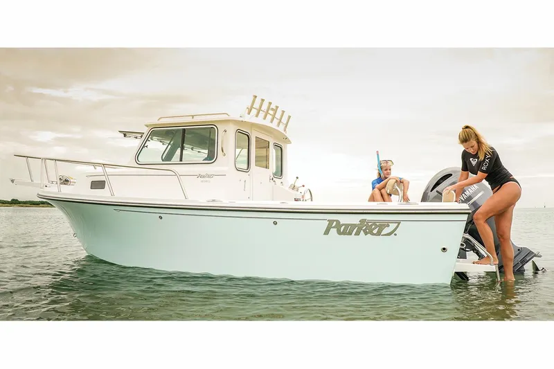 Slide: The Image of Manufacturer Provided Image: 2017 Parker 2120 Sport Cabin boat on water with two people. - 0