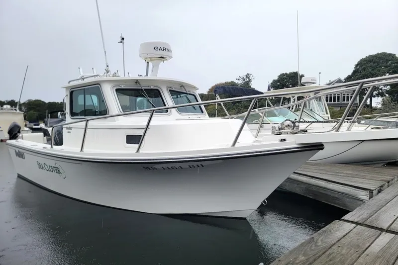 The Image of 2017 Parker 2120 Sport Cabin boat docked, featuring sleek design and Garmin equipment. - 2