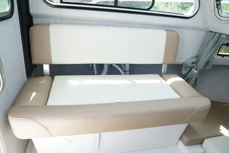 Slide: The Image of Manufacturer Provided Image: 2017 Parker 2120 Sport Cabin interior seating area with beige and white upholstery. - 3