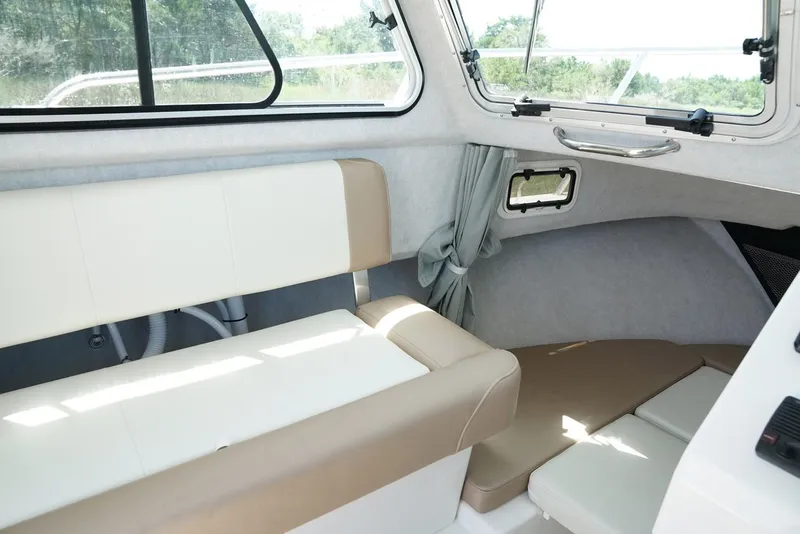 Slide: The Image of Manufacturer Provided Image: Interior of 2017 Parker 2120 Sport Cabin boat with beige and white seating. - 4