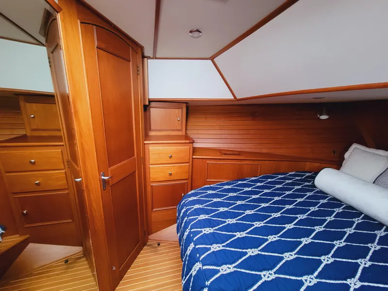 Slide: The Image of Interior of 2004 Grand Banks 49 Eastbay HX with wood furnishings and bed. - 21