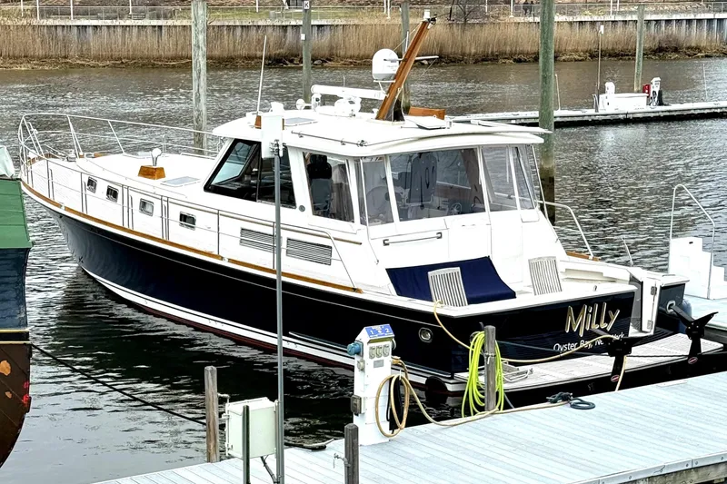 The Image of 2004 Grand Banks 49 Eastbay HX docked at marina, featuring sleek design and classic styling. - 1