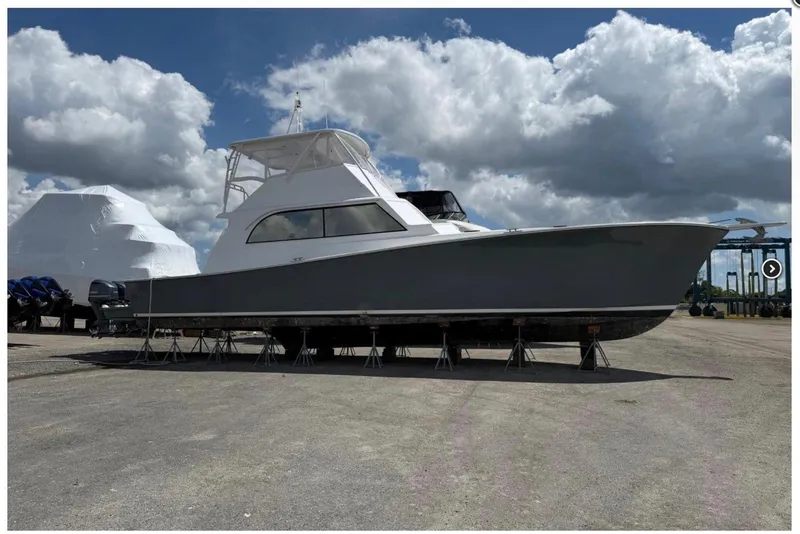 The Image of 1984 Ocean 55 Super Sport yacht on stands under a cloudy sky. - 0