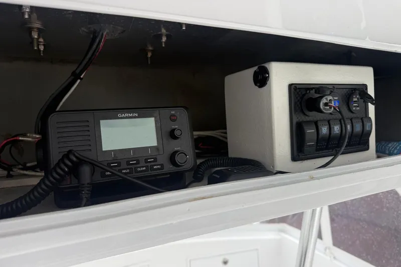 Slide: The Image of 1984 Ocean 55 Super Sport boat electronics, featuring Garmin radio and control panel. - 18
