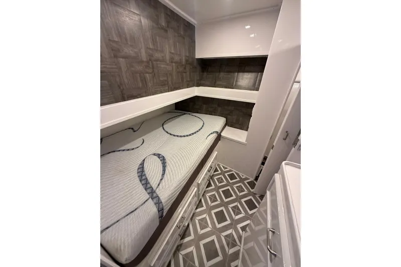 Slide: The Image of Interior cabin of 1984 Ocean 55 Super Sport yacht with bunk beds and patterned flooring. - 13