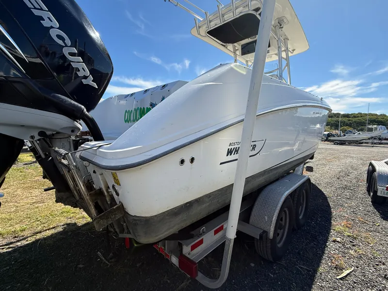 Slide: The Image of A 2006 Boston Whaler 270 Outrage on a trailer, featuring twin Mercury engines. - 50