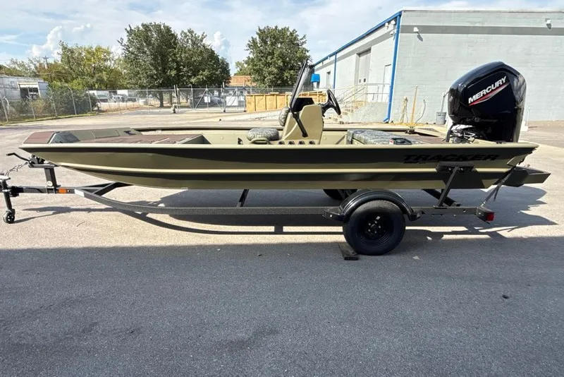 The Image of 2027 Tracker Grizzly 1860 CC boat on trailer with Mercury engine, parked outdoors. - 0