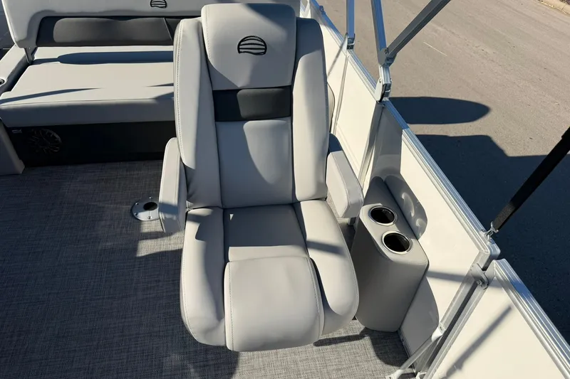 Slide: The Image of 2027 Sun Tracker Party Barge 22 RF DLX boat seat with cup holders and gray upholstery. - 21