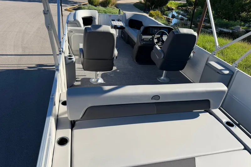 Slide: The Image of 2027 Sun Tracker Party Barge 22 RF DLX interior with seating and steering console. - 28