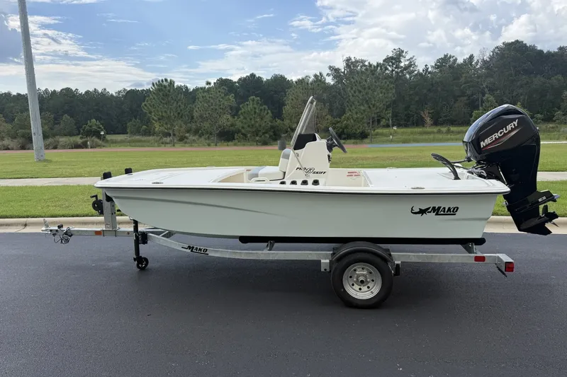 The Image of 2026 Mako Pro Skiff 13 CC boat on trailer with Mercury outboard motor. - 0