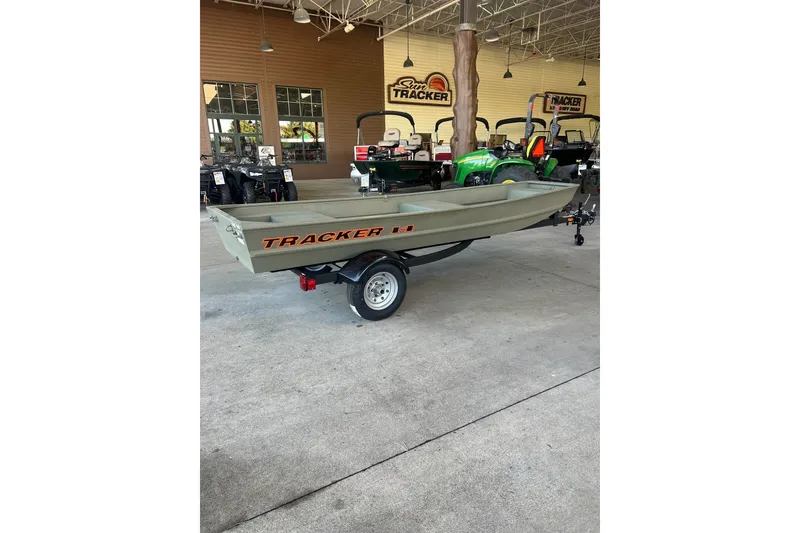 The Image of 2027 Tracker Grizzly 14 Jon boat on trailer in showroom setting. - 0