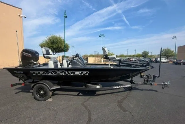 The Image of 2027 Tracker Pro Team 175 boat on trailer in parking lot. - 0