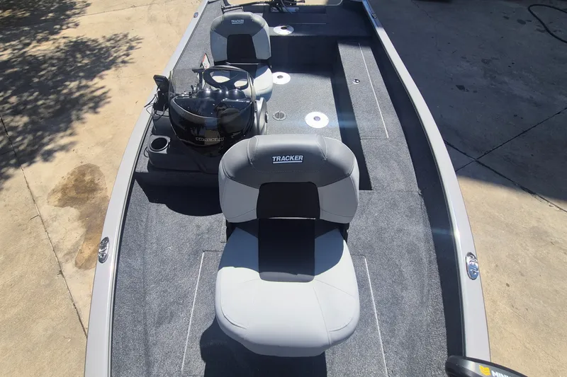 Slide: The Image of 2027 Tracker Super Guide V-16 SC boat interior with seating and motor. - 13