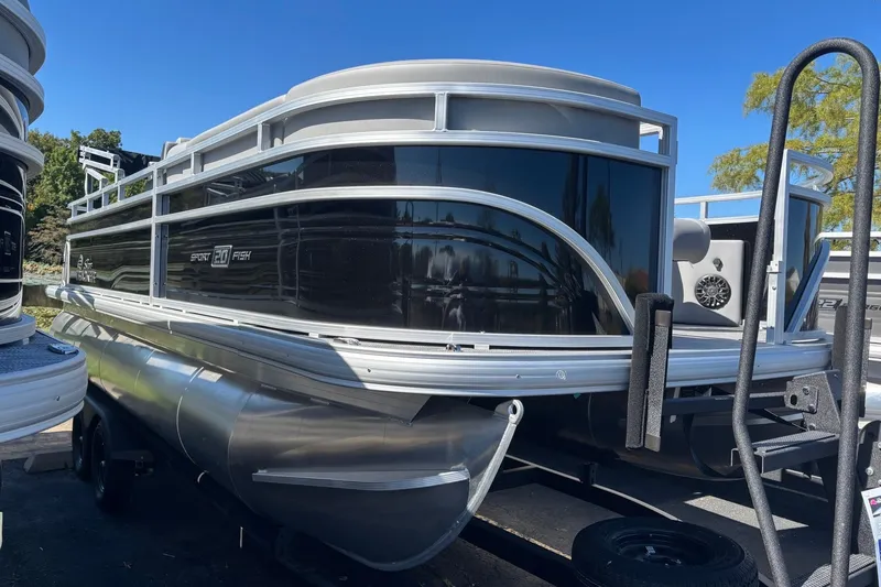 The Image of 2027 Sun Tracker SportFish 20 DLX pontoon boat with sleek black exterior. - 0