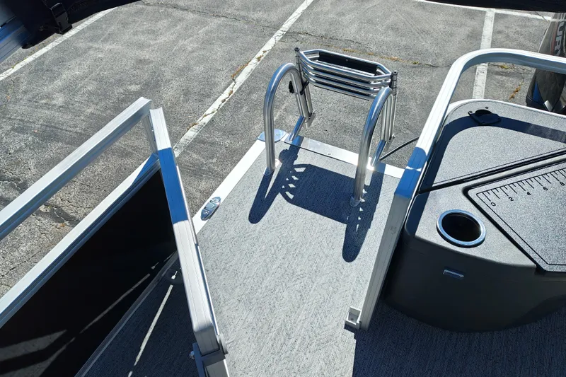 Slide: The Image of 2027 Sun Tracker Bass Buggy 18 DLX pontoon boat with ladder and deck view. - 31