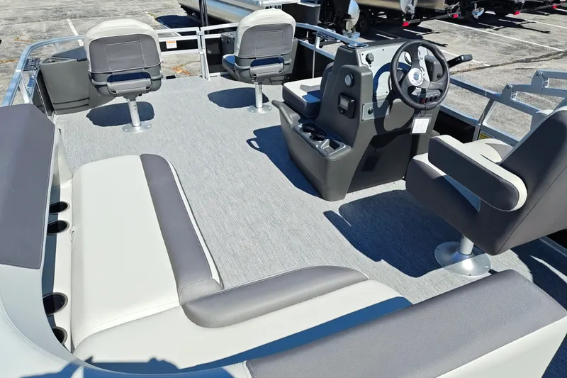 Slide: The Image of 2027 Sun Tracker Bass Buggy 18 DLX pontoon boat interior with seating and steering console. - 34