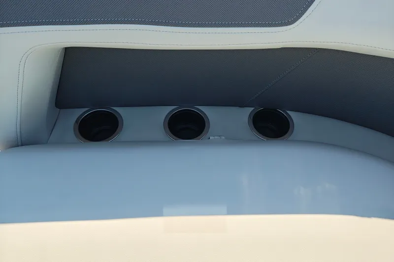 Slide: The Image of 2027 Sun Tracker Bass Buggy 18 DLX interior with cup holders and cushioned seating. - 25