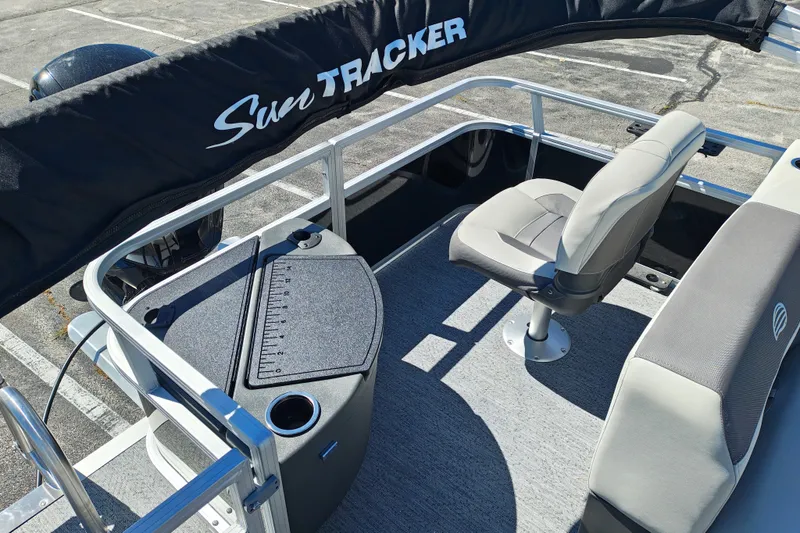 Slide: The Image of 2027 Sun Tracker Bass Buggy 18 DLX pontoon boat interior with seating and console. - 27