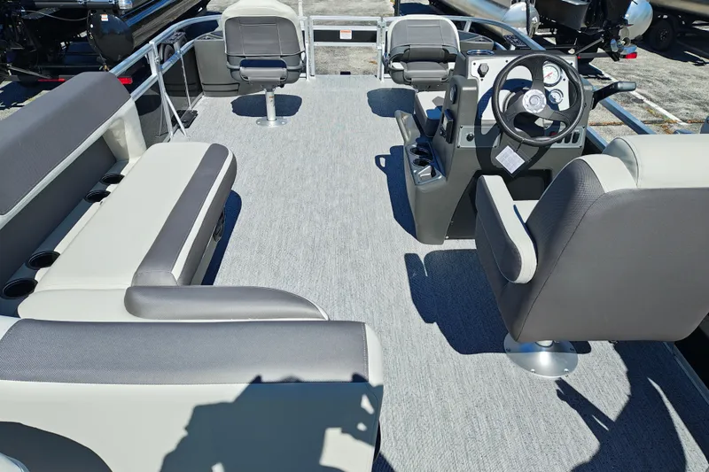 Slide: The Image of 2027 Sun Tracker Bass Buggy 18 DLX pontoon boat interior with seating and steering console. - 33