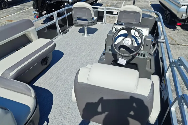 Slide: The Image of 2027 Sun Tracker Bass Buggy 18 DLX pontoon boat interior with seating and steering console. - 35