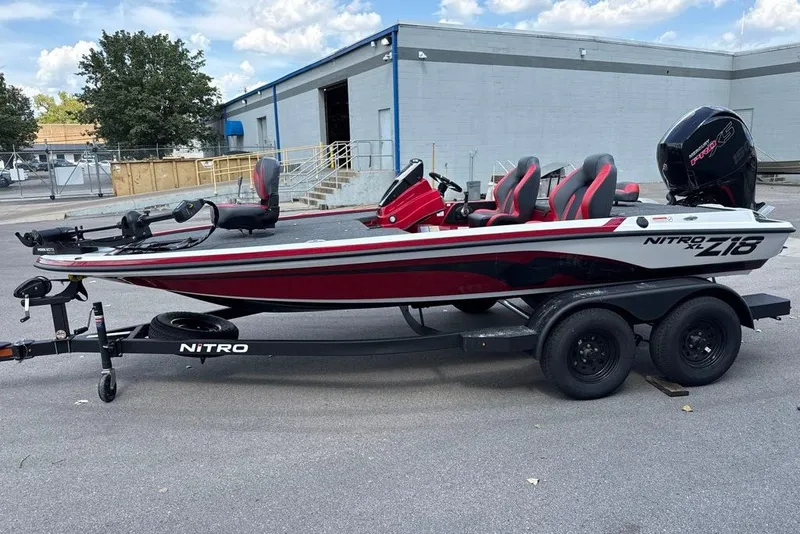 The Image of 2027 Nitro Z18 XL boat on trailer, red and white design, parked outdoors. - 0