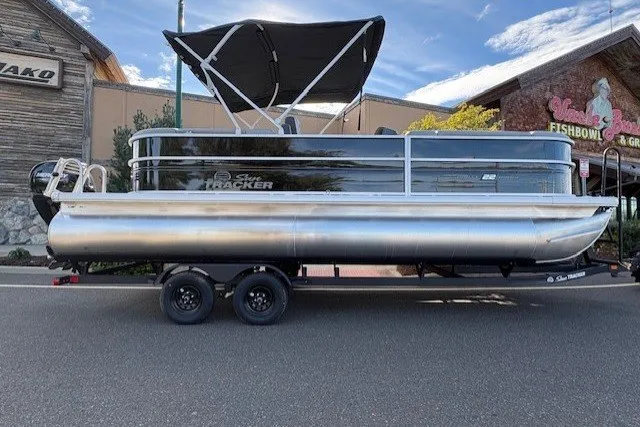 The Image of 2027 Sun Tracker Party Barge 22 DLX pontoon boat with canopy on trailer. - 0