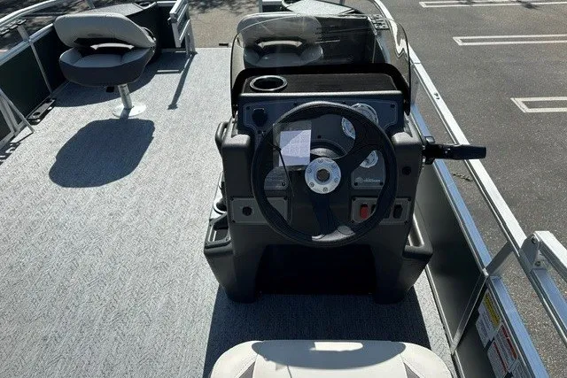 Slide: The Image of 2027 Sun Tracker Bass Buggy 18 DLX pontoon boat interior with steering console and seating. - 13