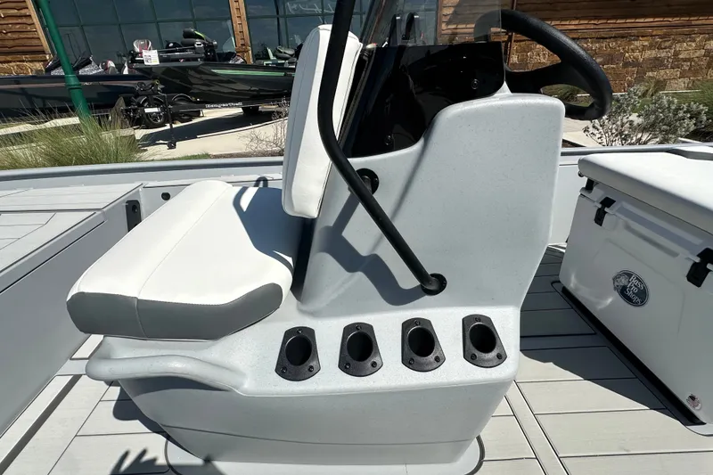 Slide: The Image of 2027 Tracker Bass Tracker Classic CC boat console with seating and rod holders. - 19
